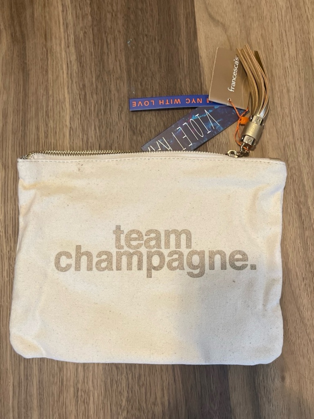 Francesca's Collections Cream Canvas 'team champagne.' Pouch with Tassel